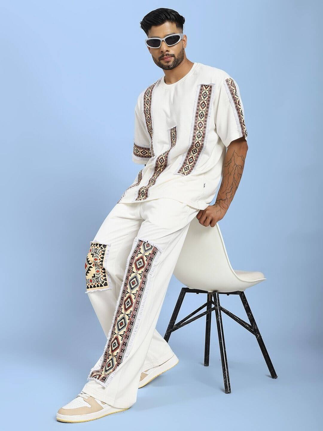 Model wearing YARA GEOMETRIC PRINT CO-ORD SET OFF-WHITE, stylish two-piece ensemble with geometric patterns, perfect for casual outings.