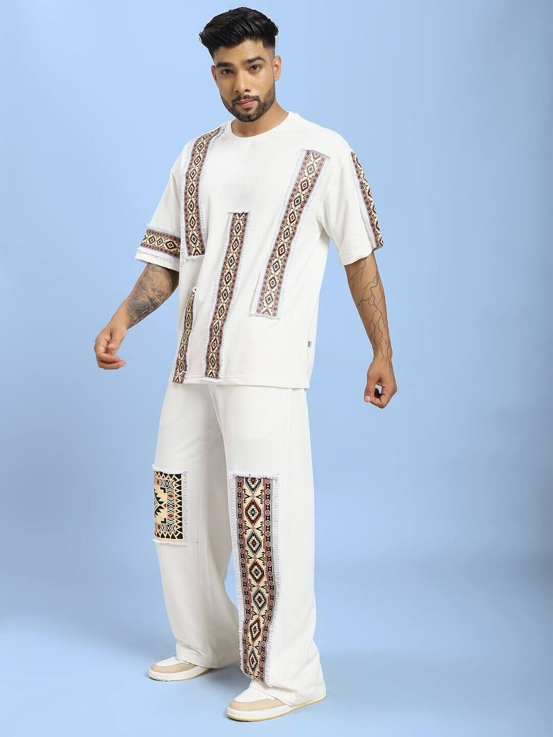 Man wearing YARA GEOMETRIC PRINT CO-ORD SET OFF-WHITE, featuring chic geometric pattern on a stylish two-piece.