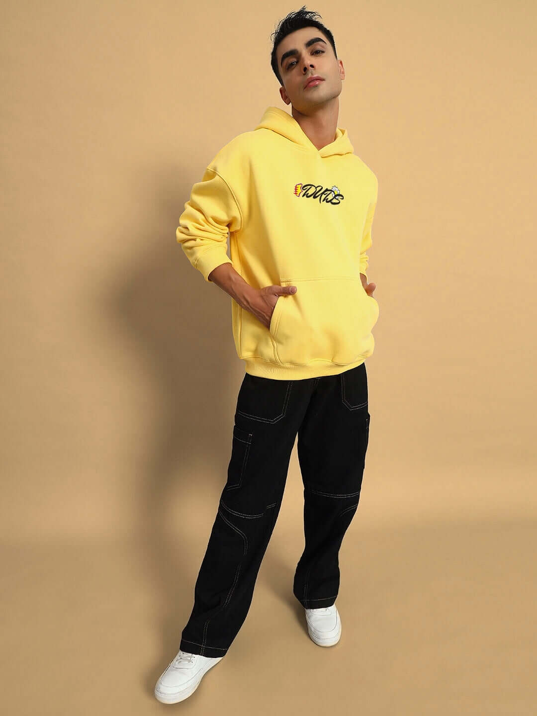 Model wearing CONFUSED FLEECE OVERSIZED HOODIE YELLOW, showcasing vibrant streetwear style.