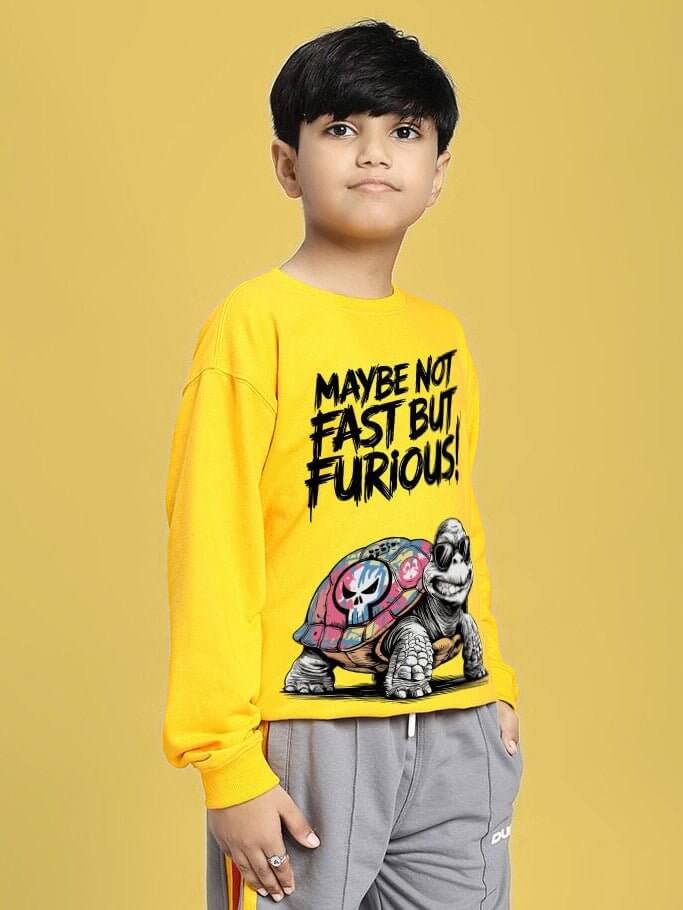 Child wearing NOT FAST BUT FURIOUS PRINT SWEATSHIRT BOYS AND GIRLS YELLOW with playful turtle graphic.