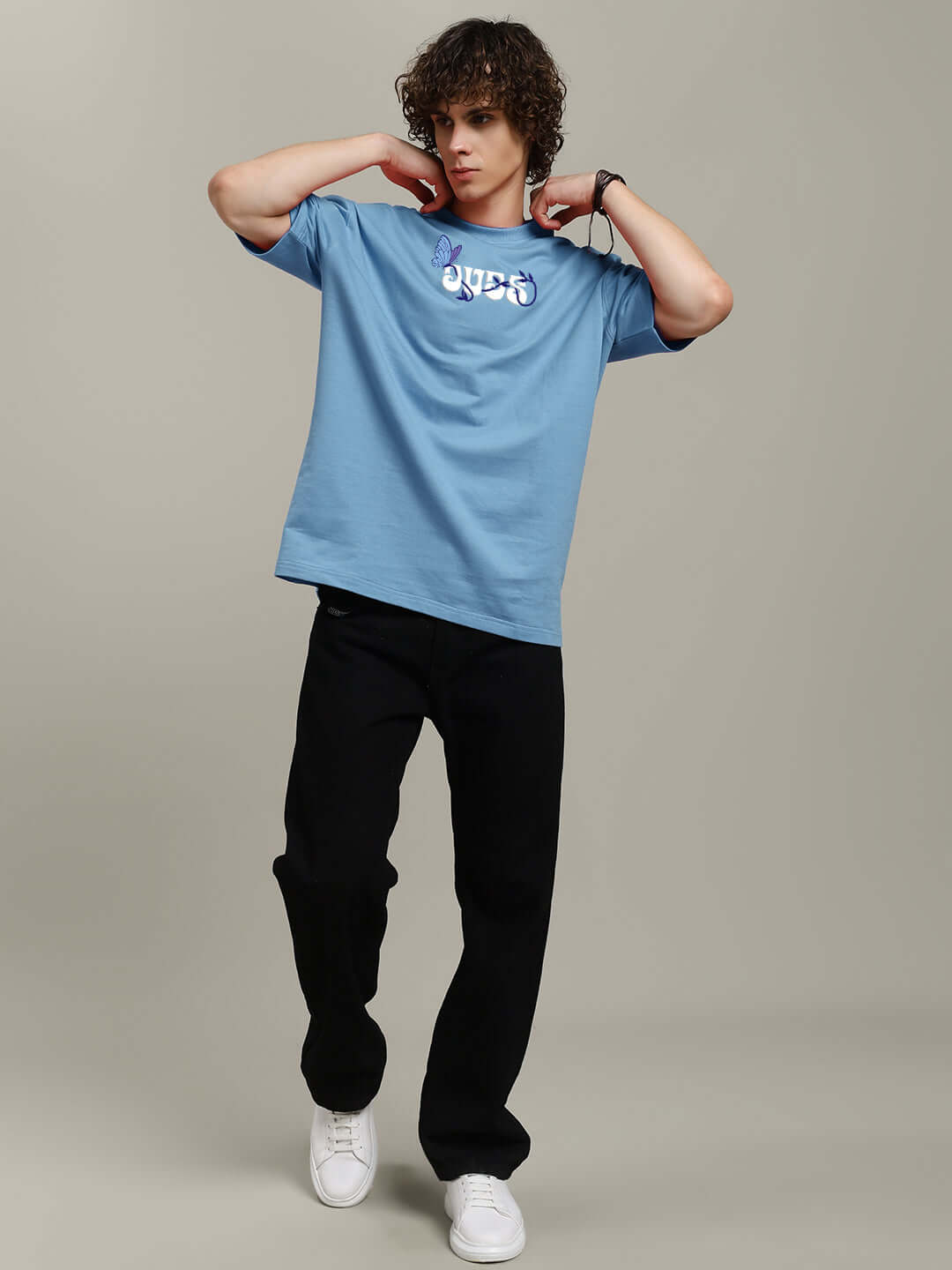 Man wearing light blue 'Your Feeling Printed' t-shirt, made from premium cotton French terry, paired with black pants.