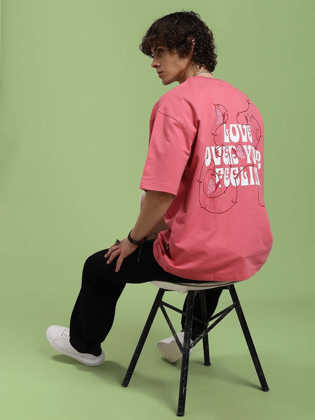 Model wearing YOUR FEELING PRINTED T-SHIRT PINK with bold graphic design, casual style.