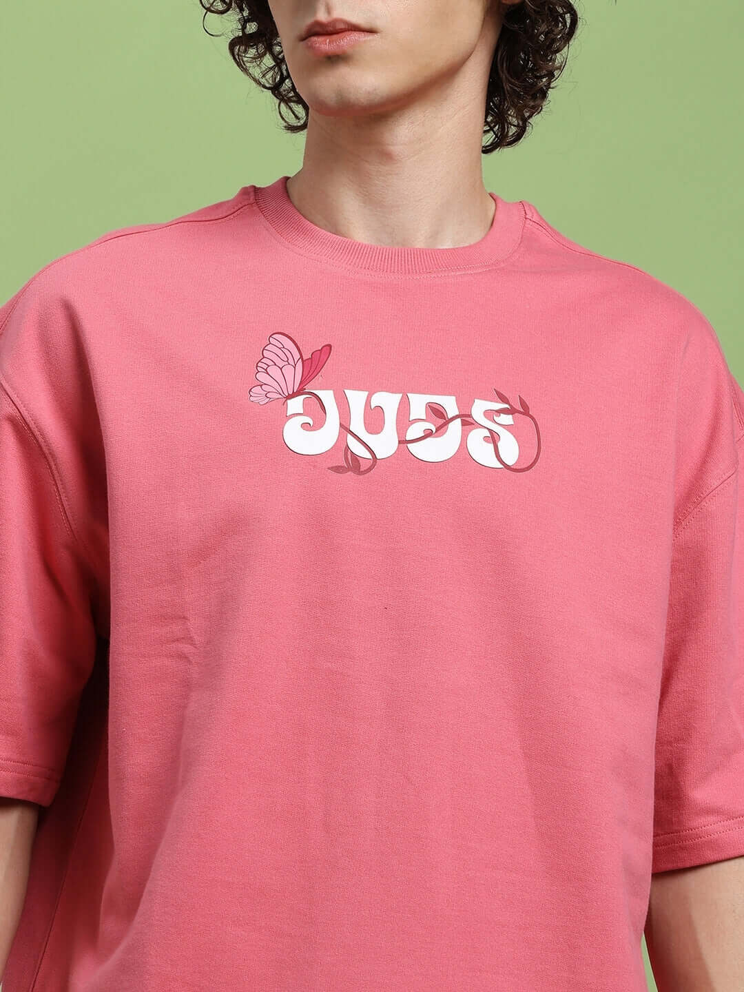 Model wearing YOUR FEELING PRINTED T-SHIRT PINK with bold graphic design, showcasing casual comfort and playful fashion style.