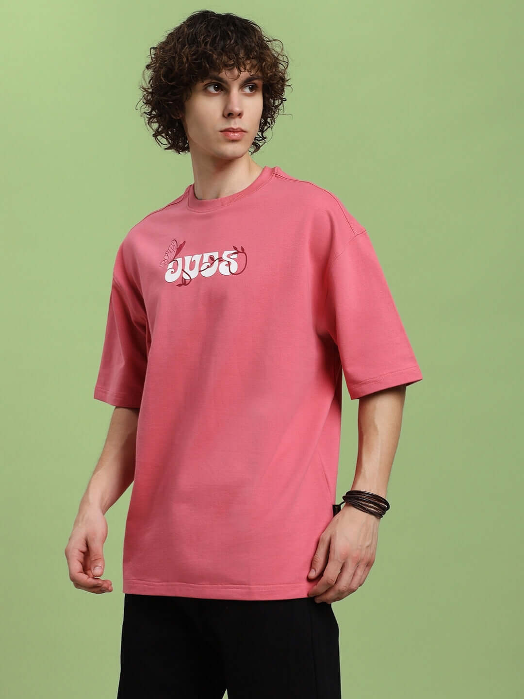 Model wearing YOUR FEELING PRINTED T-SHIRT PINK with graphic design, showcasing casual fashion style.