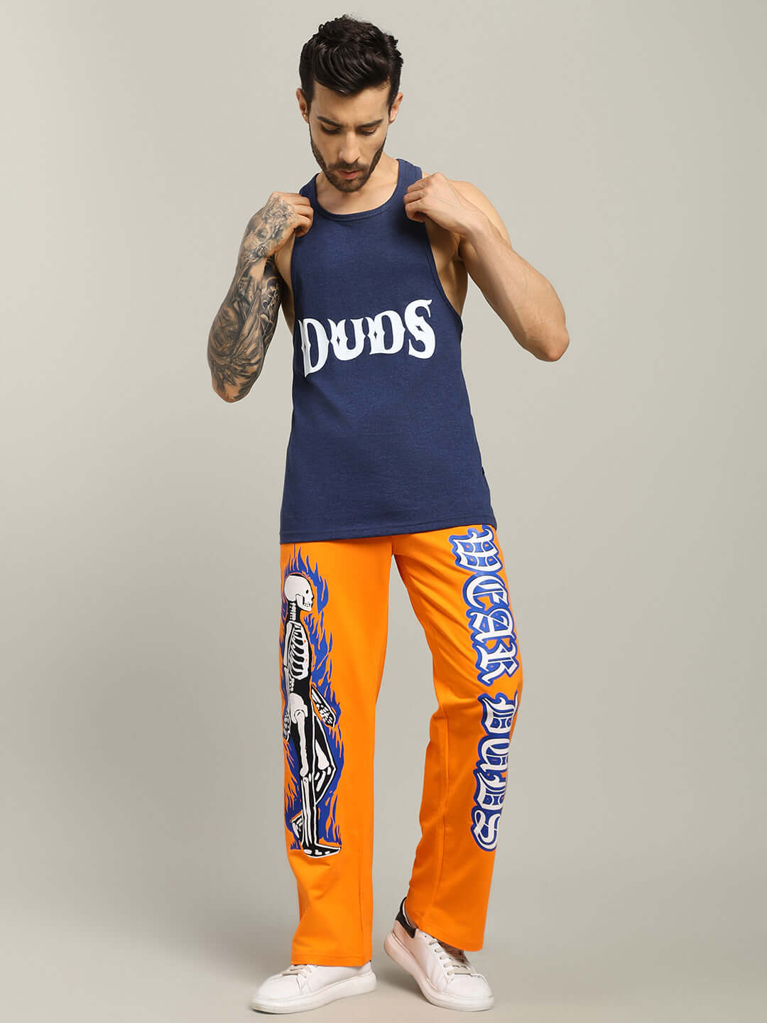 Model wearing ZEMPA FITNESS GYM T-SHIRT in blue with customized orange graphic pants, showcasing fitness apparel style.