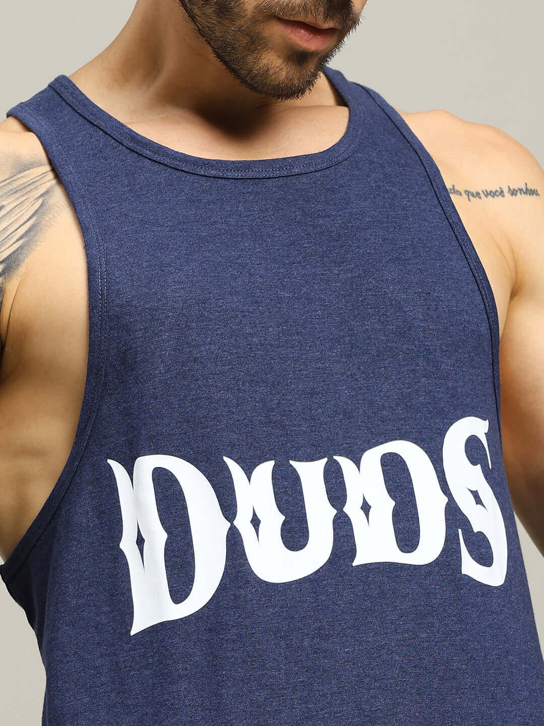 Man wearing blue ZEMPA FITNESS gym t-shirt with 'DUDS' logo, showcasing athletic fit and style.