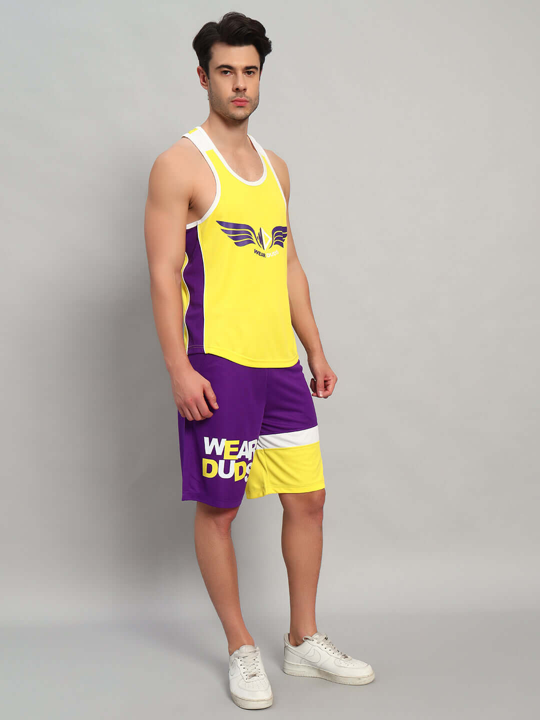 Man wearing ZENITH GYM CO-ORD SET YELLOW-PURPLE featuring vibrant athletic design, perfect for stylish workouts.