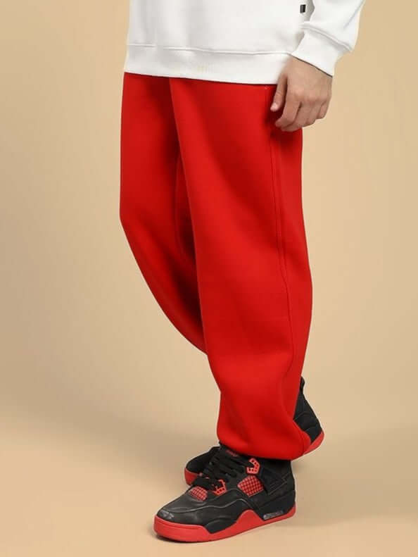 Model wearing ZENO RELAXED FIT FLEECE JOGGER RED, featuring ultra-soft brushed fleece and modern silhouette tapering at the ankle.