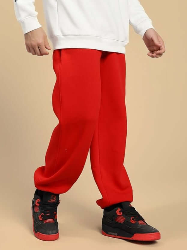 Person wearing ZENO RELAXED FIT FLEECE JOGGER RED showcasing the bold design and modern silhouette.