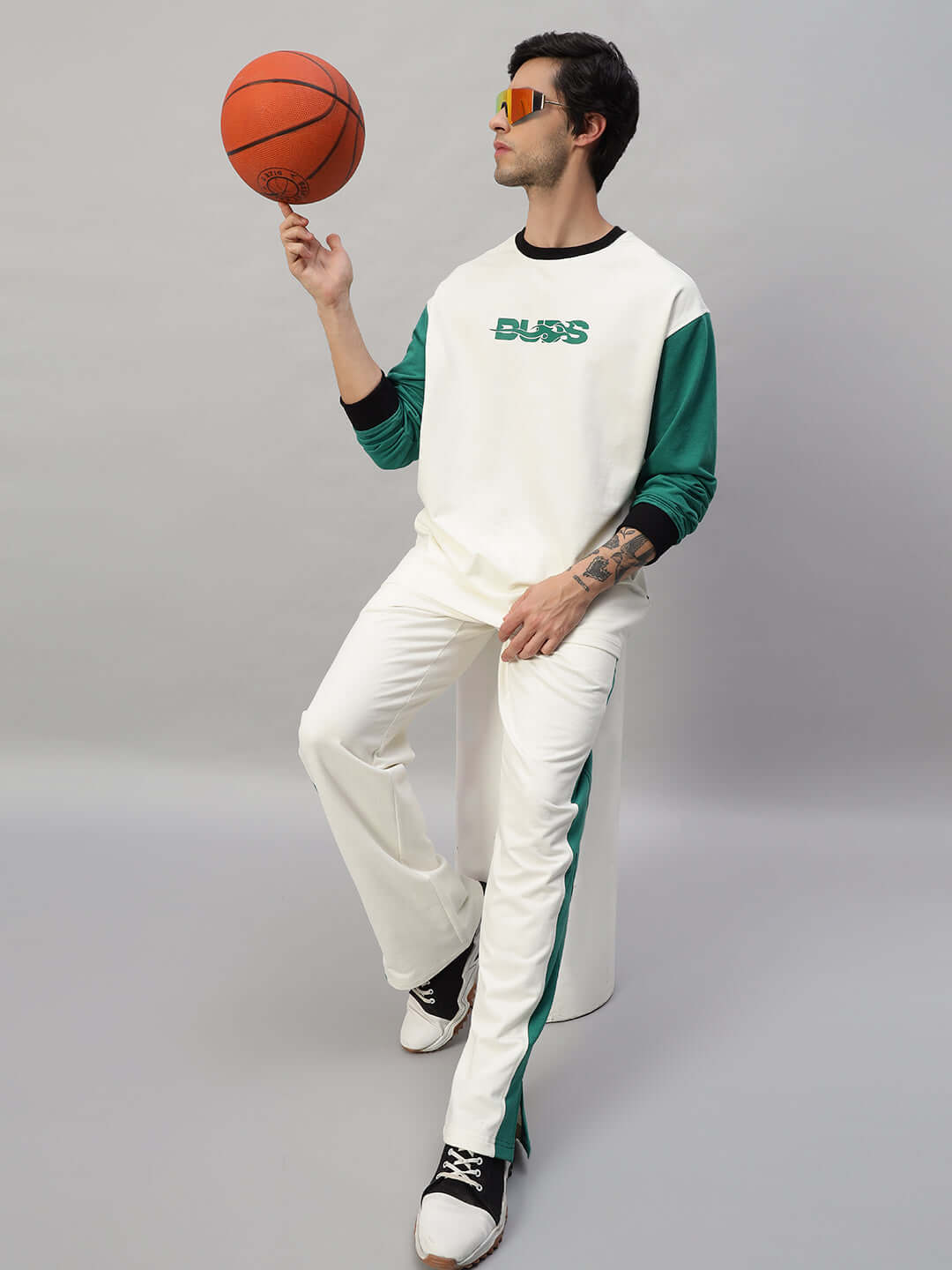 Model wearing ZINGY OVERSIZED CO-ORD SET OFF WHITE TEAL with contrast panel joggers, holding a basketball.