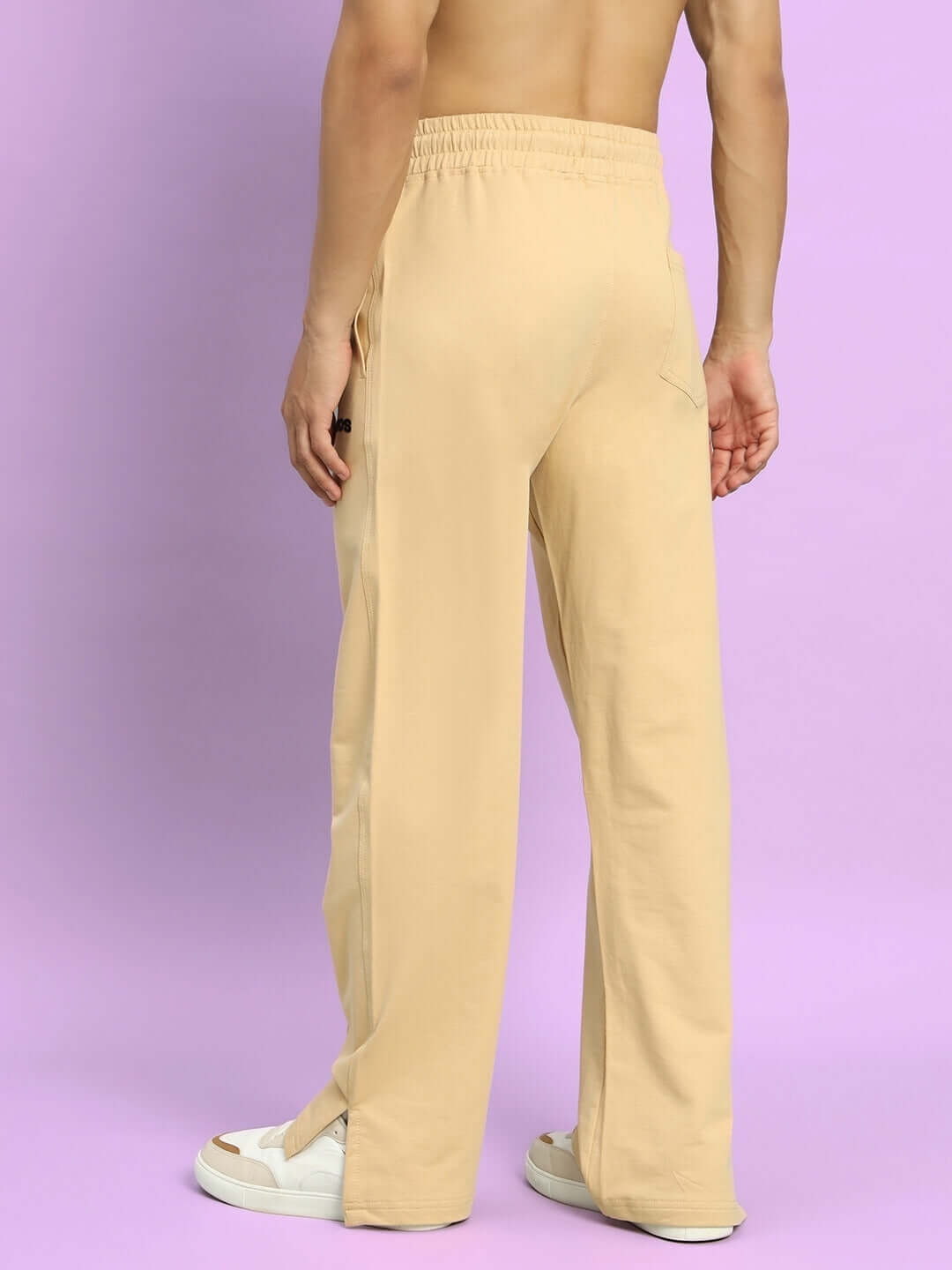 Back view of Zion Side Slit Joggers in beige, highlighting comfortable fit and style. Ideal for custom tailoring by DUDS.