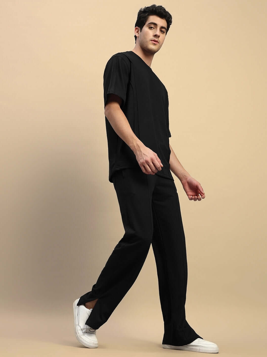 Unisex black co-ord set with relaxed fit joggers and T-shirt, featuring elasticated waistband and drawstring, perfect for casual wear.