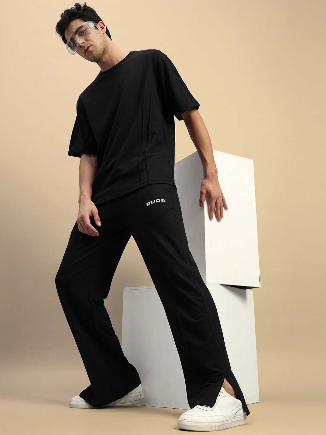 Model wearing ZION Relaxed Fit Co-ord Set in black, featuring unisex joggers with elastic waistband and drawstring, paired with a matching T-shirt.