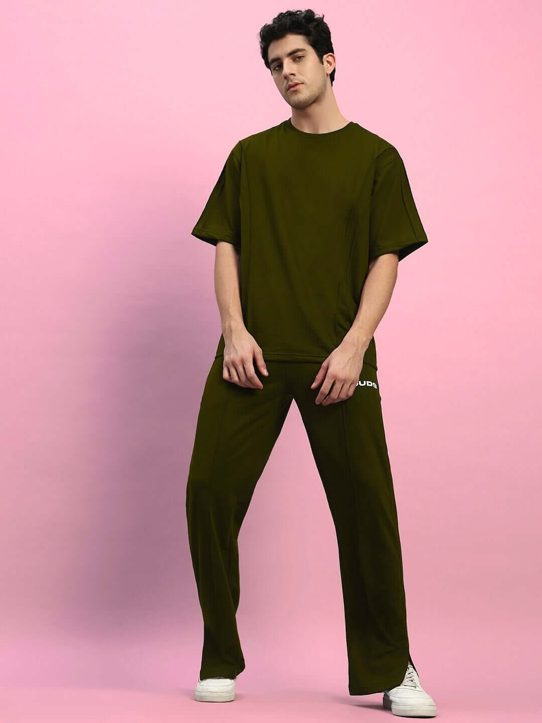 Model wearing ZION relaxed fit olive green co-ord set, featuring a unisex cotton t-shirt and joggers with elasticated waistband for comfort.