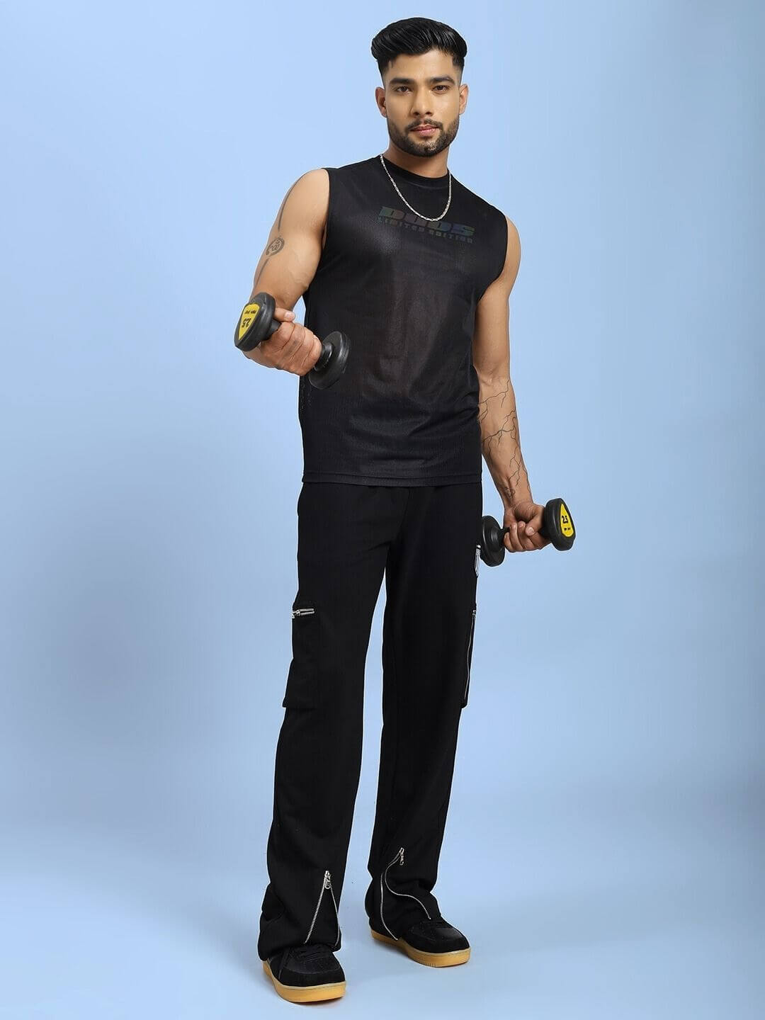 Alt Tag: Man wearing ZIP TECH PREMIUM CARGO IN BLACK, holding dumbbells, showcasing stylish water-resistant cargo pants for versatile urban utility.