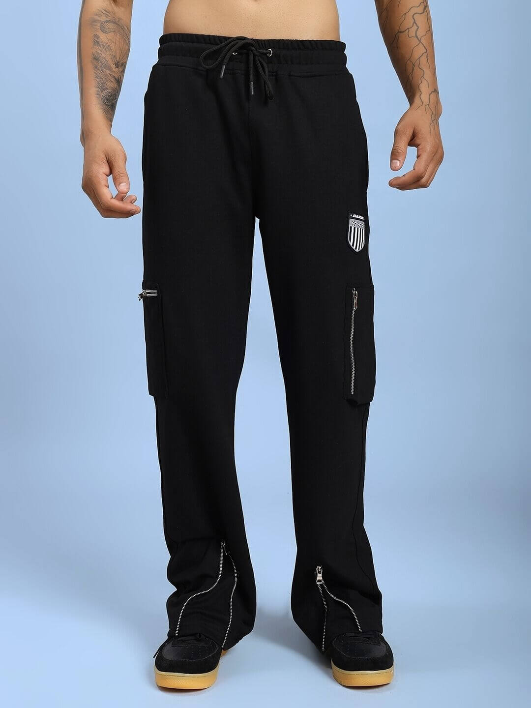 Model wearing ZIP TECH PREMIUM CARGO IN BLACK, showcasing sleek tactical design pants with water-resistant fabric and modern functionality.