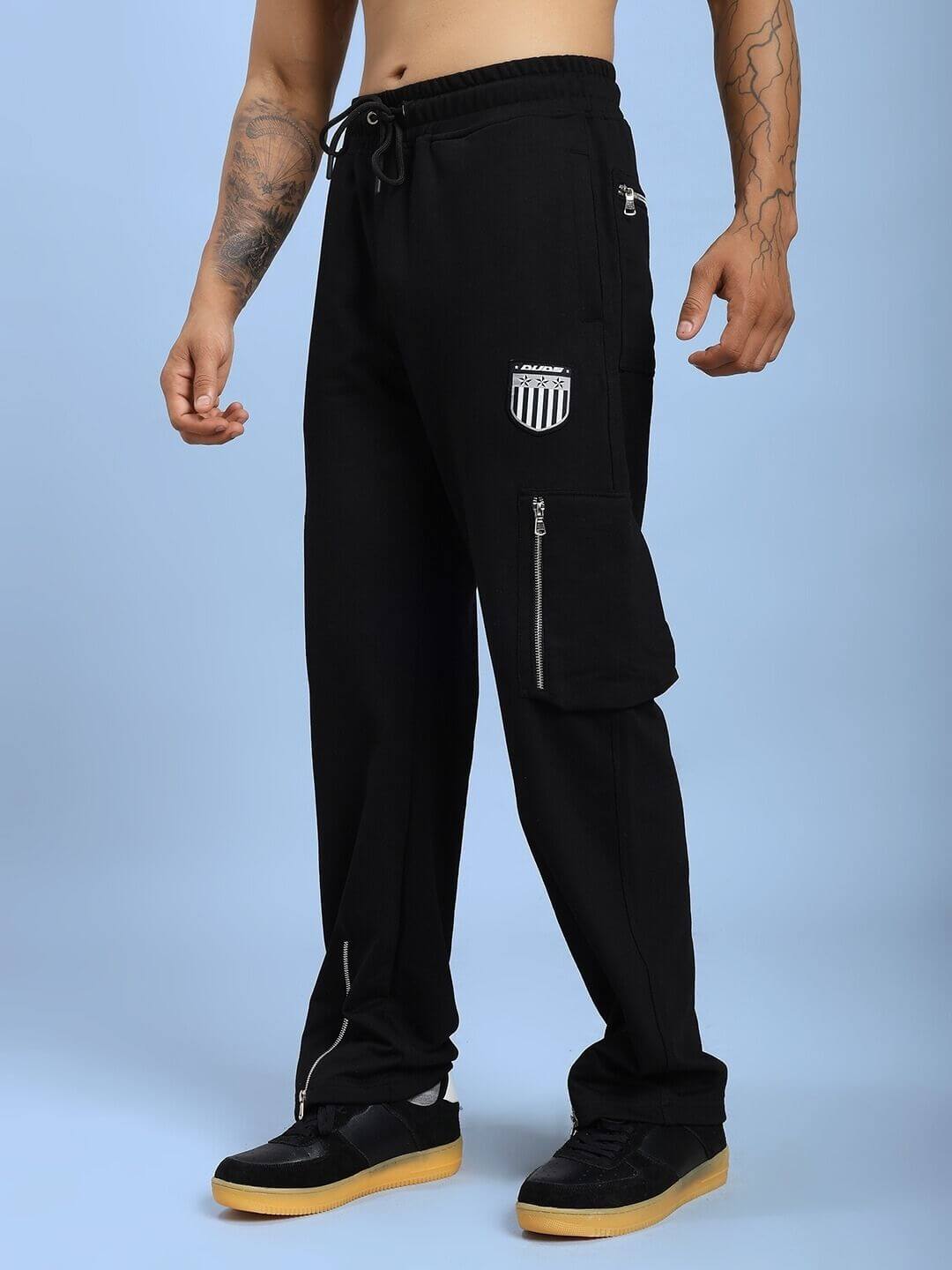 Man wearing ZIP TECH PREMIUM CARGO IN BLACK, showcasing sleek design and cargo pants functionality.