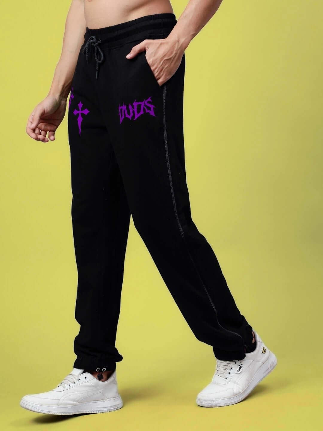 Black joggers with purple zipper panel design, made from 97% cotton French terry lycra and 3% elastane, offering comfortable fit.