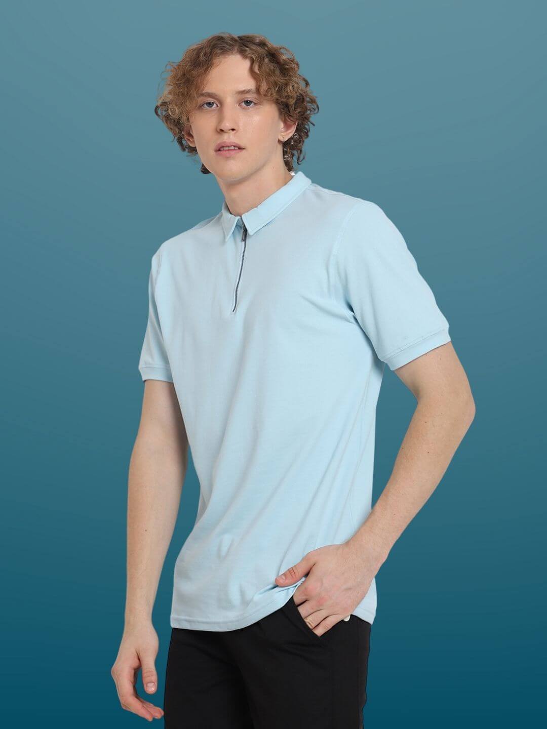 Model wearing powder blue zipper polo neck T-shirt made from sporty pique cotton with superior stretch and quick-dry features.