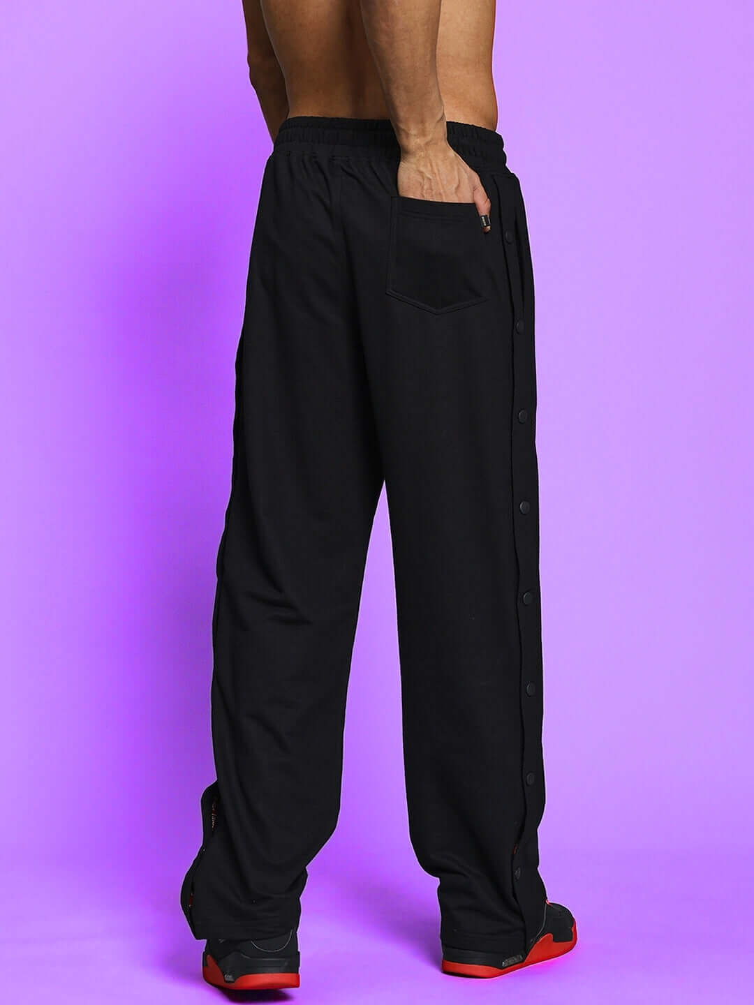 Back view of ZONEX black-red co-ord set pants on model against a purple background.