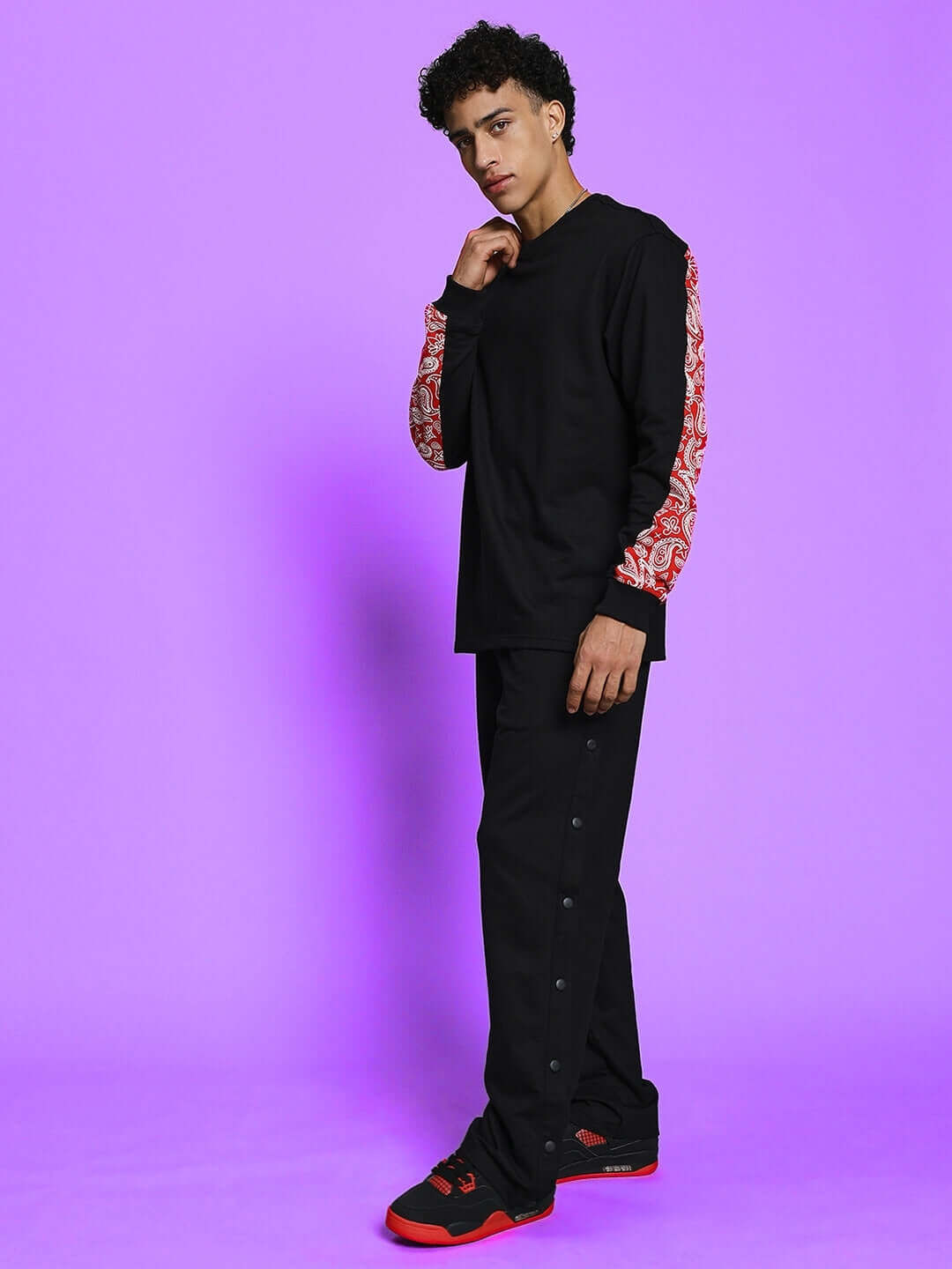 Model wearing ZONEX black-red co-ord set featuring unique sleeve design, available in custom sizes, crafted by DUDS tailors.