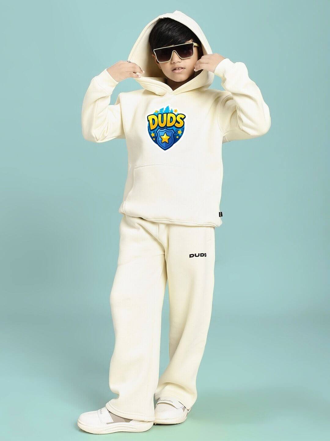 Child wearing ZOOTOPIA WORLD FLEECE HOODIE FOR BOYS AND GIRLS OFF WHITE with playful design, showing cozy comfort in stylish kids fashion.