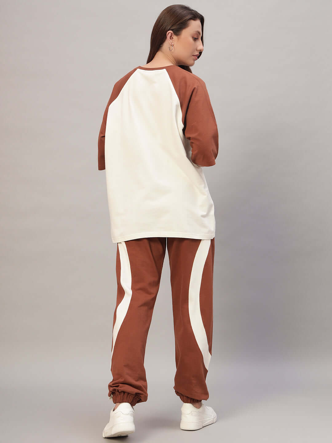 Woman wearing Women's Cocoa Co-ord Set in off white and brown, made from premium cotton French Terry Lycra, showcasing back view.