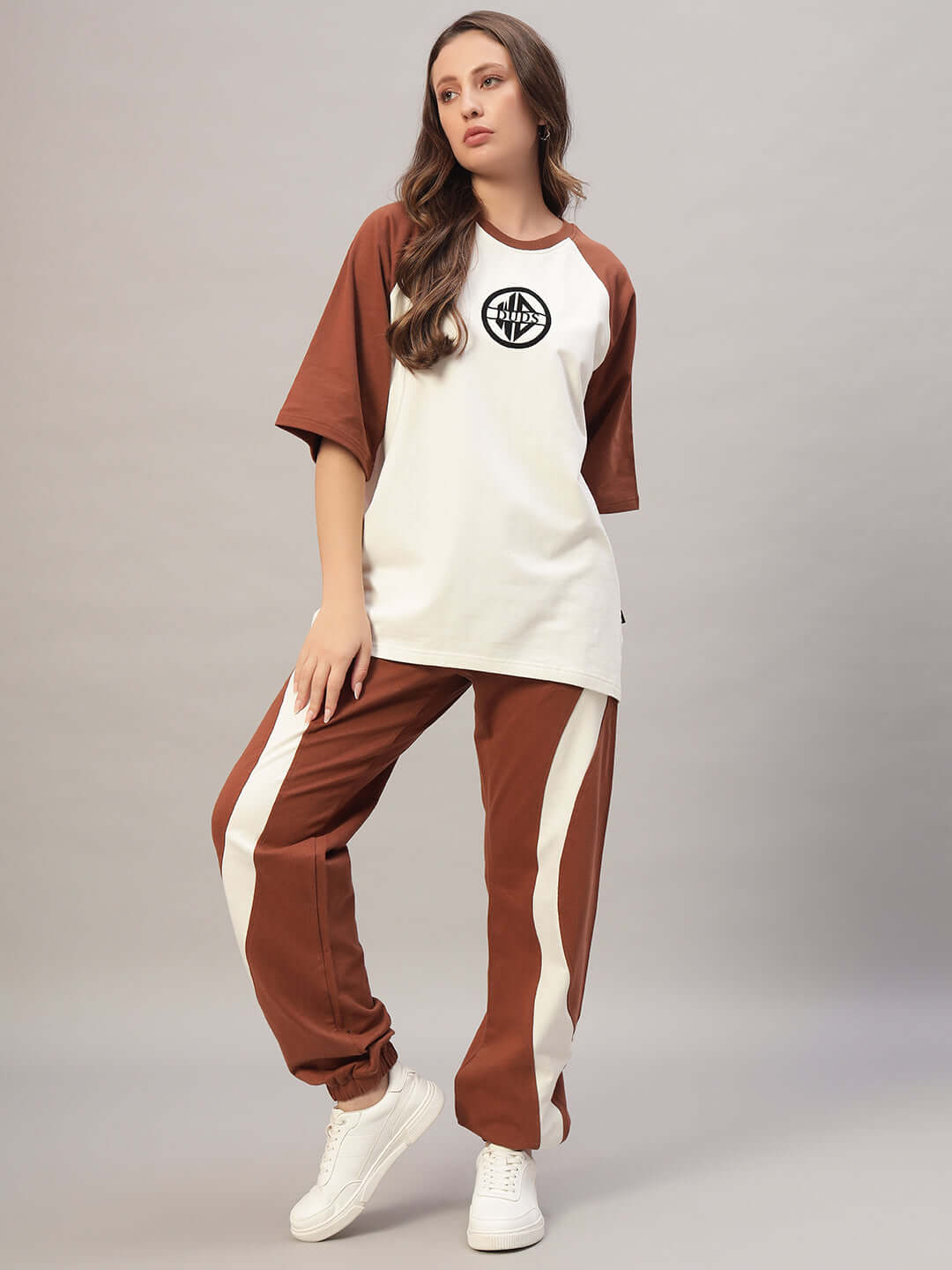 Woman wearing off white-brown co-ord set made from premium cotton French terry lycra, featuring a stylish, comfortable fit.