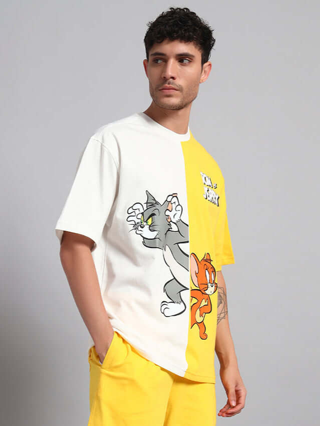 Off-white and yellow oversized Tom & Jerry t-shirt, featuring a cartoon print, perfect for trendy summer looks with breathable cotton fabric.