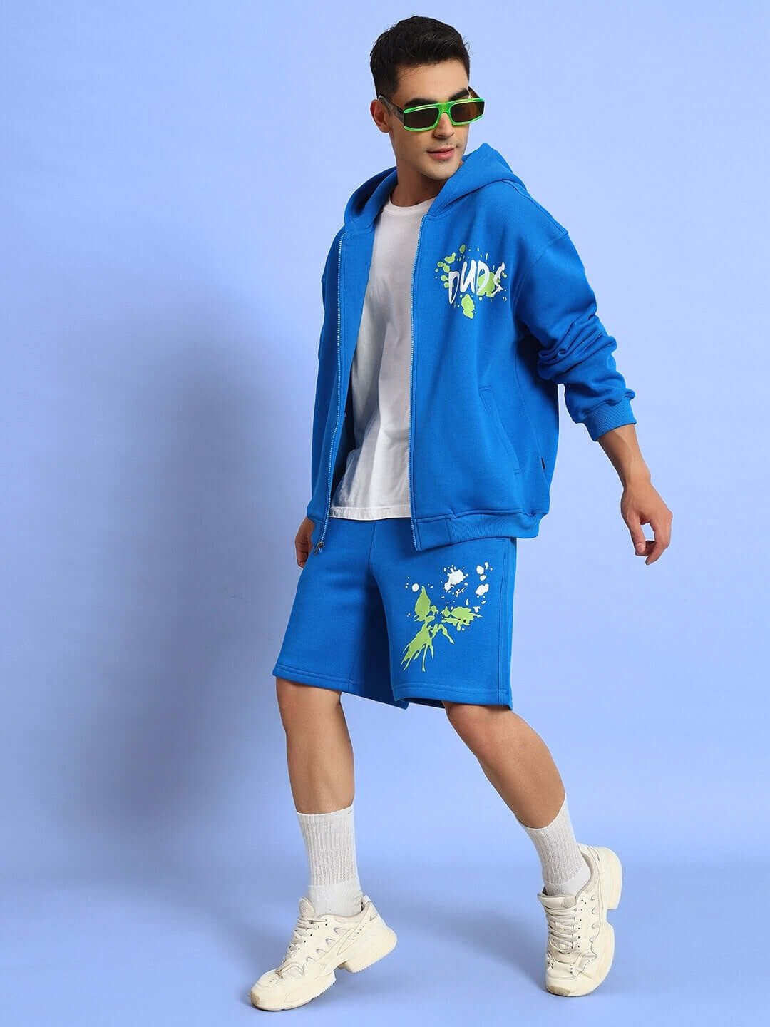Royal blue no drama fleece co-ord set featuring a hoodie and shorts, styled with sunglasses for a trendy casual look.