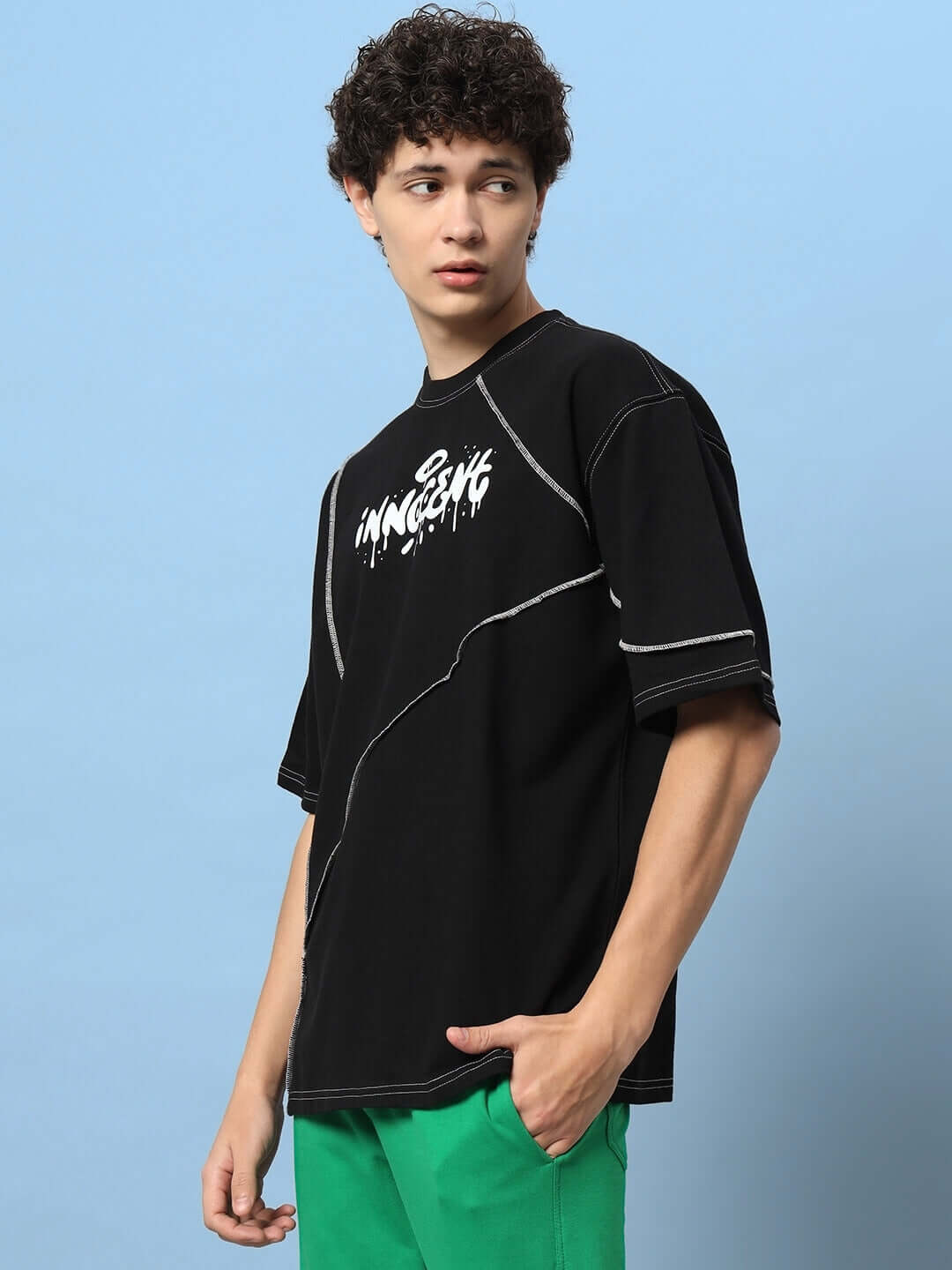 INNOCENT CONTRAST STITCHED OVER-SIZED T-SHIRT BLACK on model with premium heavy gauge fabric, featuring contrast stitching.