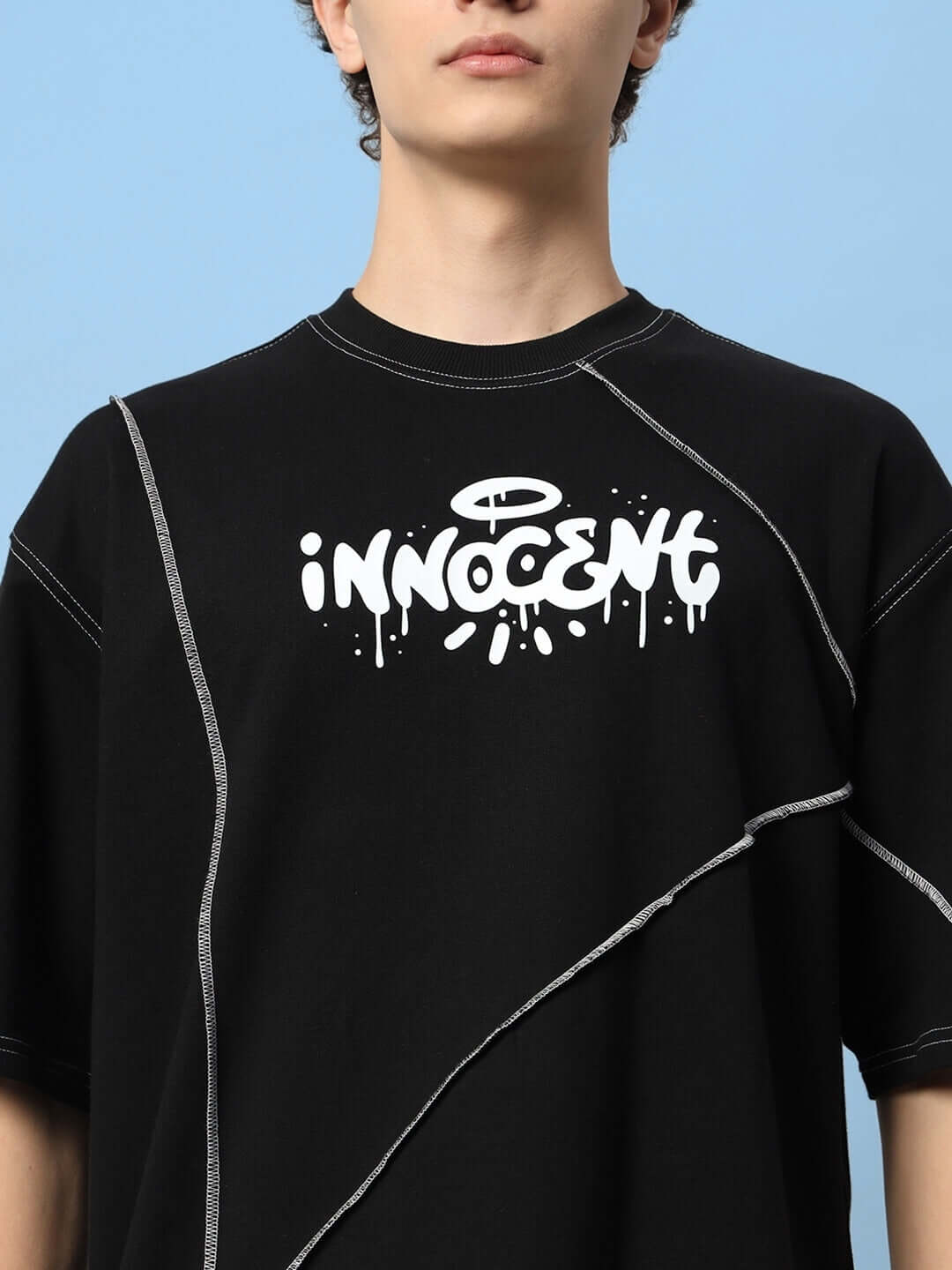 INNOCENT CONTRAST STITCHED OVER-SIZED T-SHIRT BLACK with premium cotton fabric, featuring distinctive white logo design.