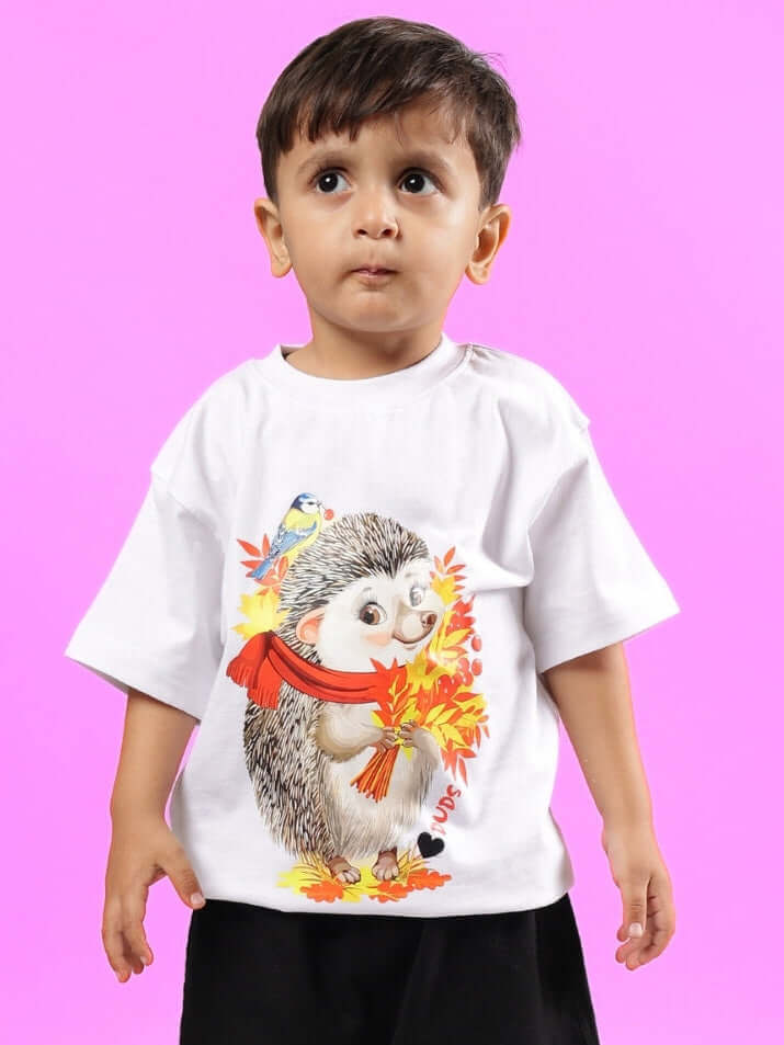 Boy wearing a white hedgehog t-shirt with autumn leaves design.