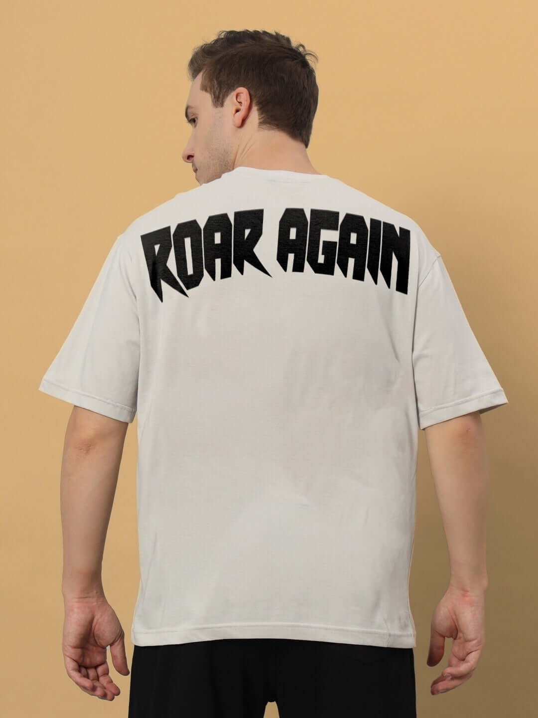 Back view of grey Roar Again printed oversized t-shirt made from premium 100% cotton fabric, featuring bold text design.