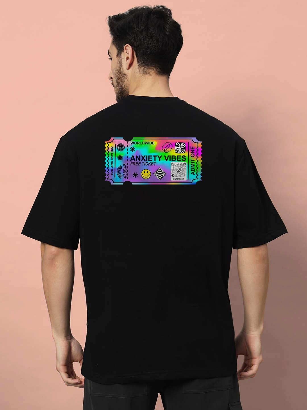 Man wearing GOHAN OVER-SIZED T-SHIRT OFF WHITE with colorful graphic on the back.