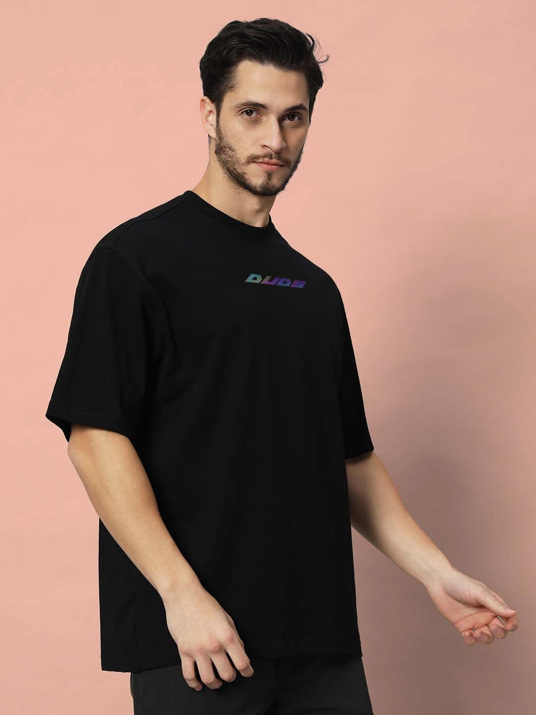 Model wearing GOHAN OVER-SIZED T-SHIRT OFF WHITE with DUDS logo, showcasing customizable fit option for personalized style.