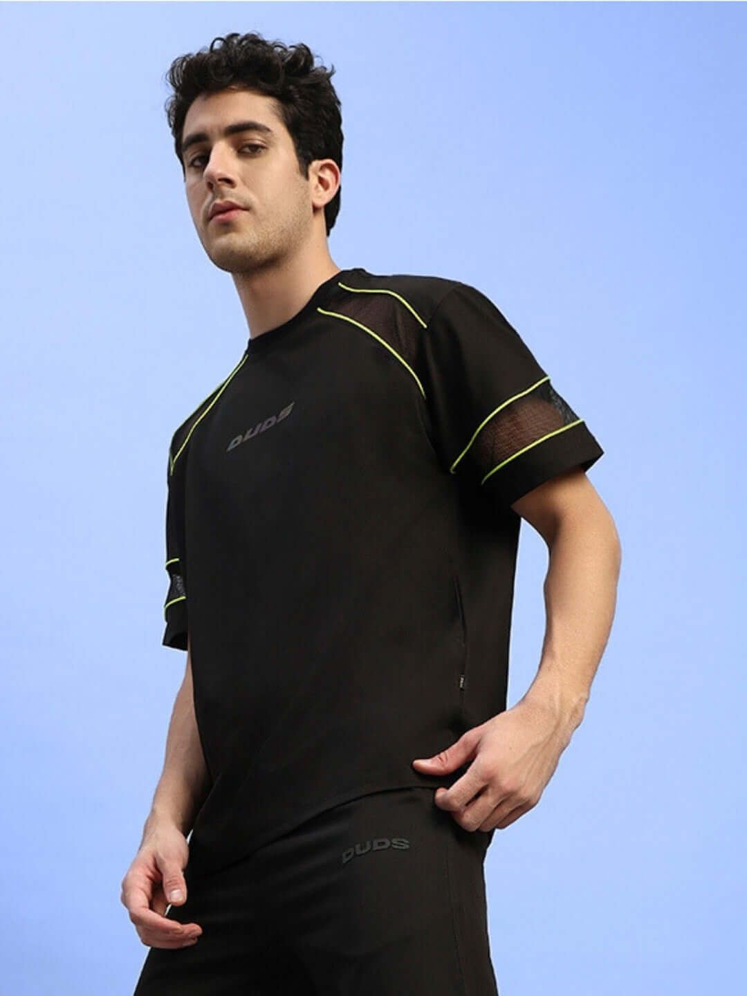 Model wearing Salvo Reflector Regular Fit Black T-Shirt in sports polyester fabric for a stylish look.