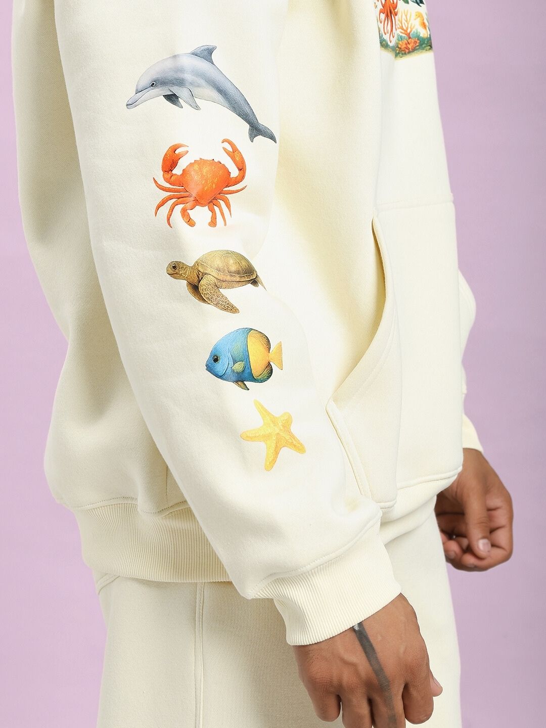 Side view of OCEAN BUDDIES FLEECE CO-ORD SET OFF-WHITE featuring sea-themed graphics on sleeve