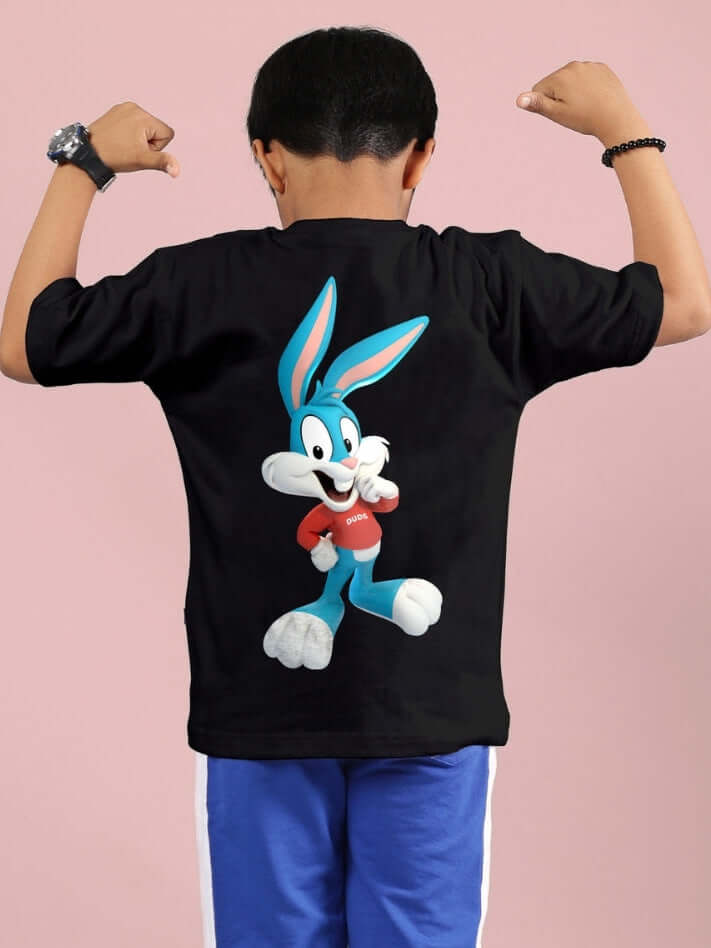 Boy wearing a black Tiny Toon printed T-shirt with cartoon design, showcasing a playful character, suitable for boys and girls.