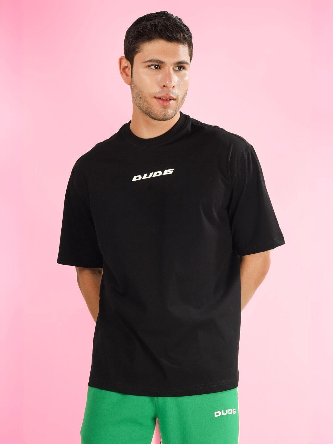 Model wearing ENJOY THE WIND OVER-SIZED T-SHIRT BLACK by DUDS, showcasing relaxed fit style.