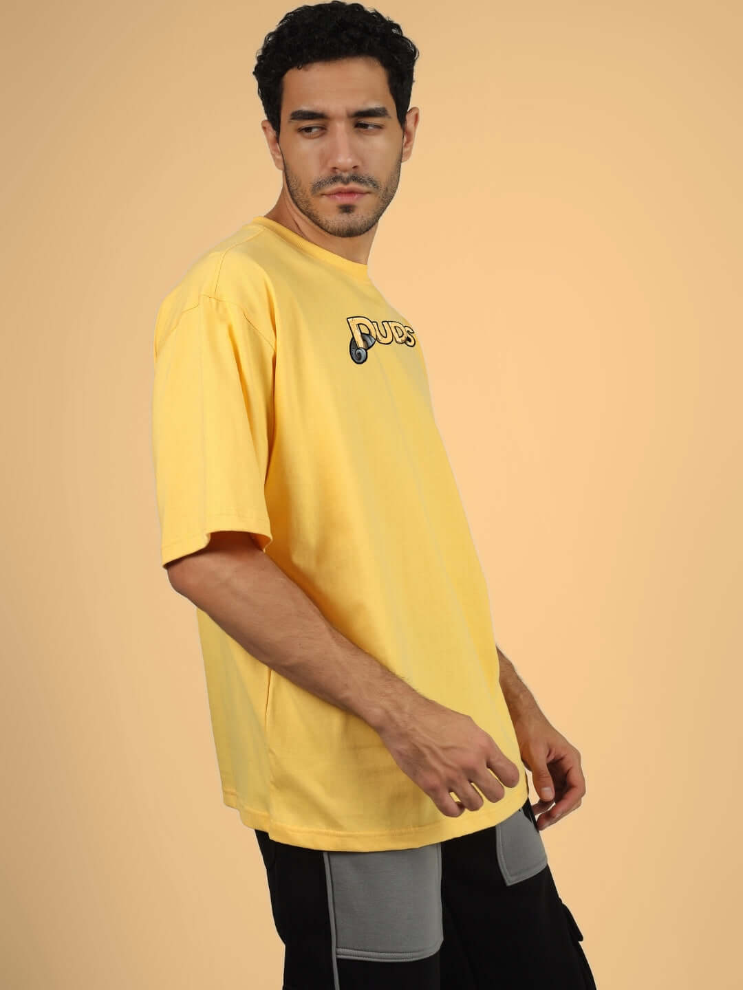 DUCK TALES OVER-SIZED T-SHIRT YELLOW worn by a male model against a neutral background