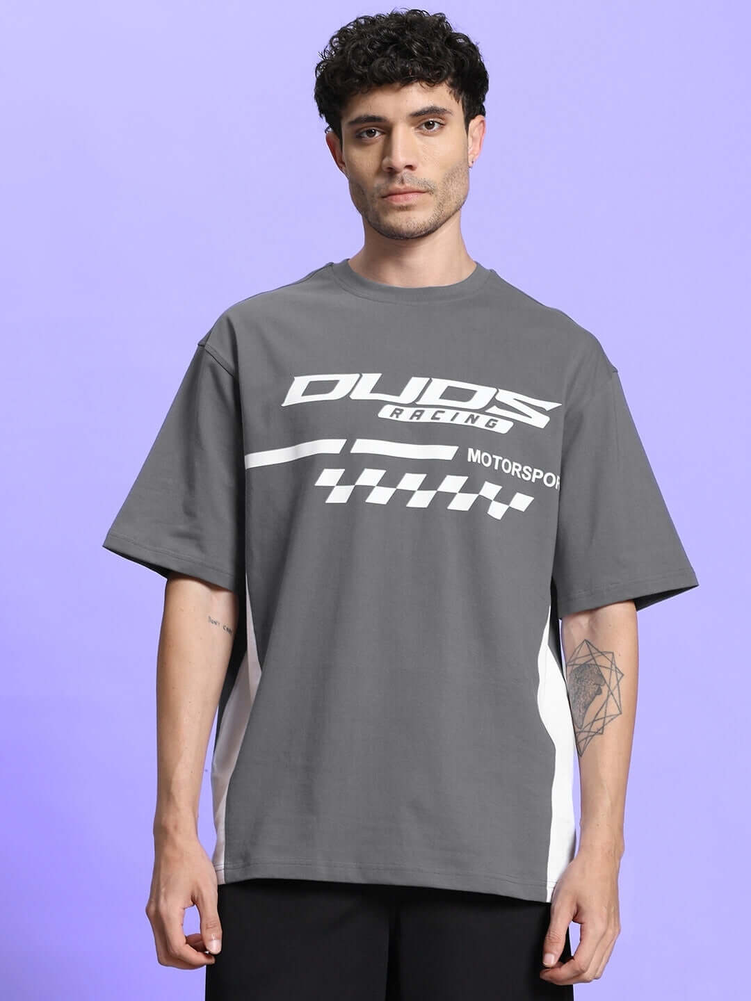 Model wearing grey oversized classic t-shirt made from premium cotton French terry, featuring motorsport print, perfect for casual style.