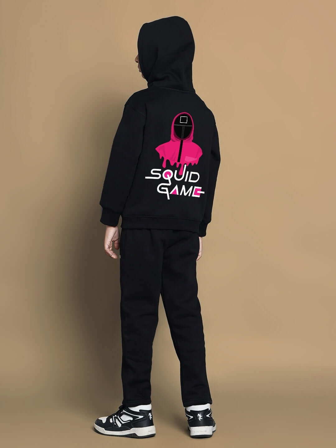 Child wearing black Squid Game fleece co-ord set with graphic design, full view.