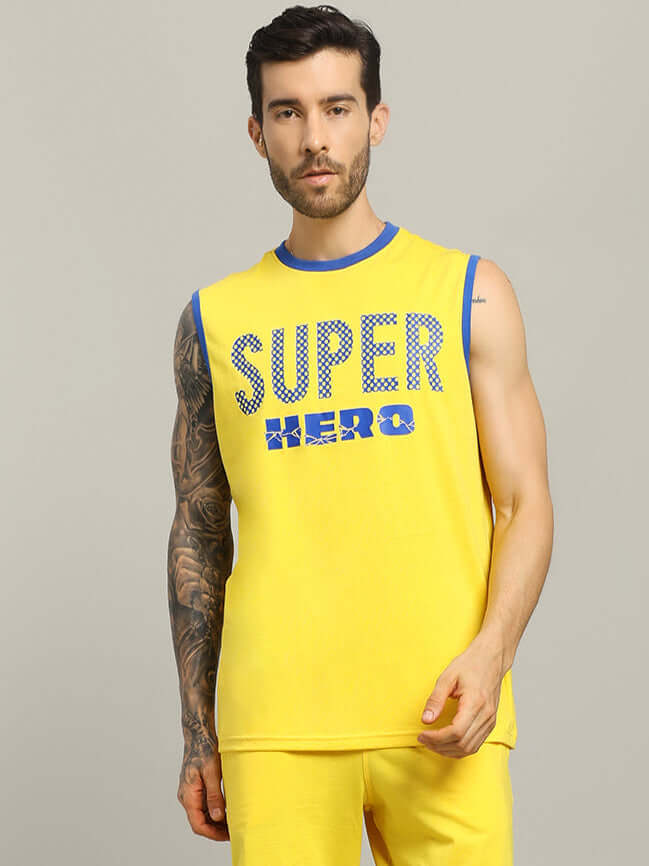 Yellow SUPER HERO oversized t-shirt with blue trim, featuring bold text design, worn by a model for casual summer style.