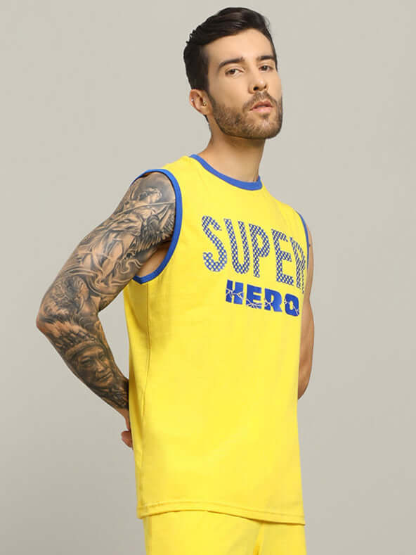 Model wearing yellow SUPER HERO oversized t-shirt for trendy summer look.