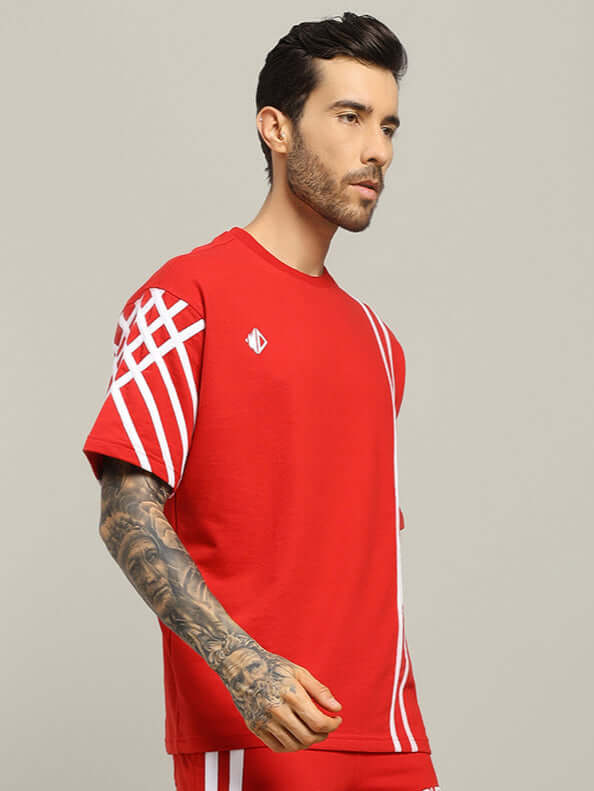 Model wearing UNITED STRIPE oversized red T-shirt made from 97% premium cotton French terry, showcasing bold white stripes.