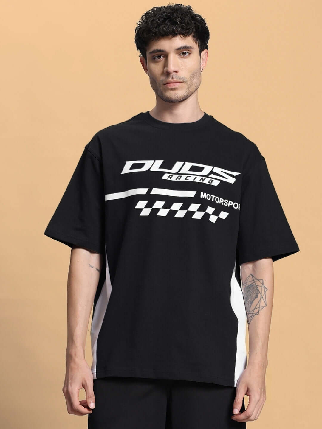 Model wearing INDY Over-Sized Classic Black T-Shirt made from premium cotton, featuring a motorsport-inspired graphic design.