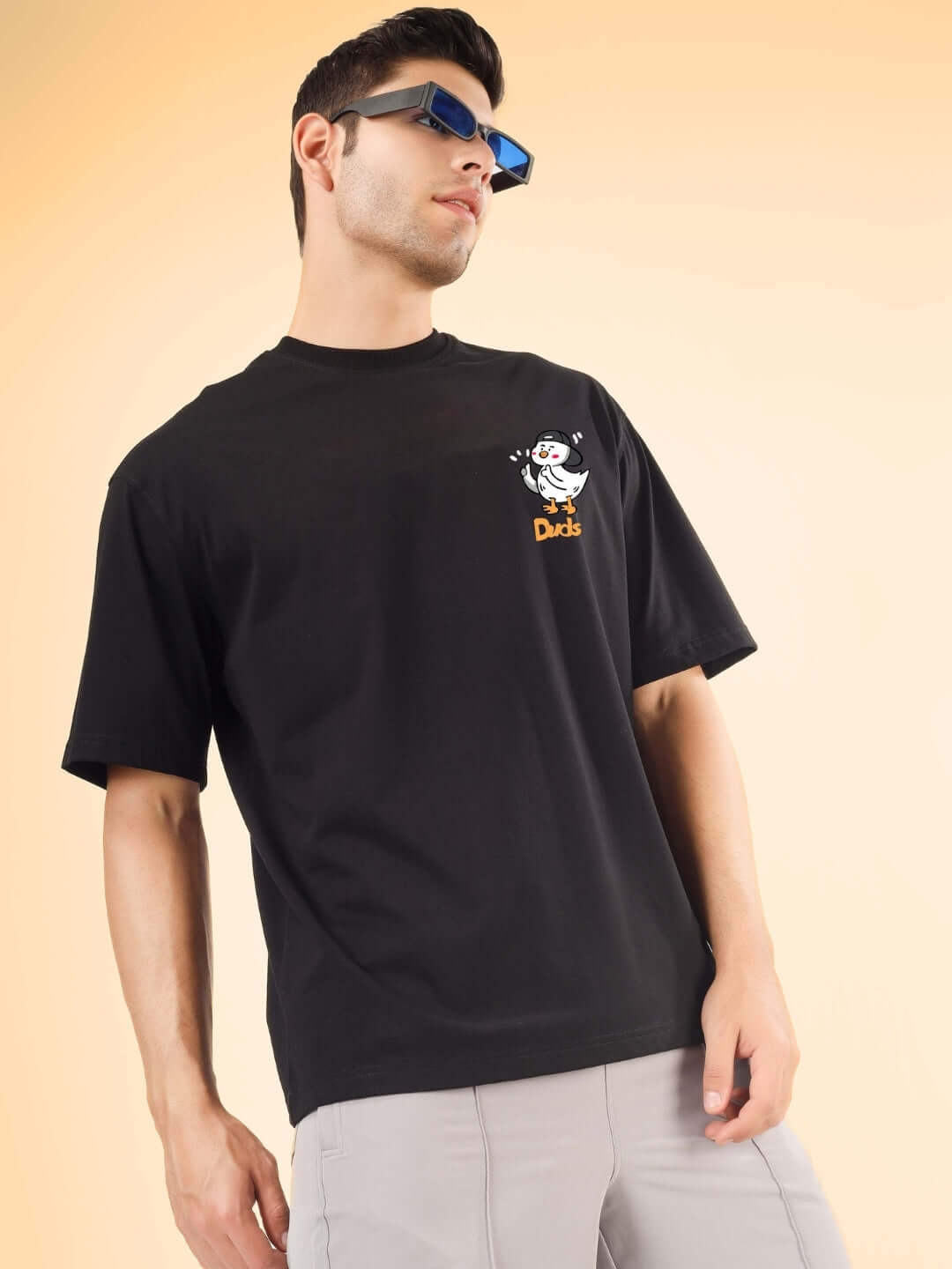 Model wearing GO MOTION OVER-SIZED T-SHIRT BLACK, showcasing custom fit option, perfect for a casual and stylish look.