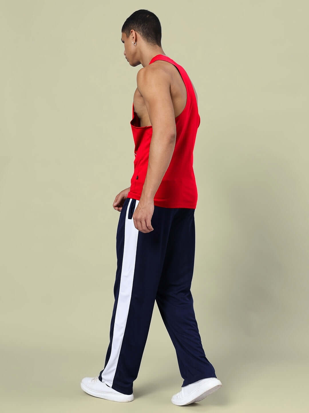 Model wearing DUDS KINGDOM Gym Co-Ord Set in red and navy-blue with elasticated joggers, showcasing a side view style.