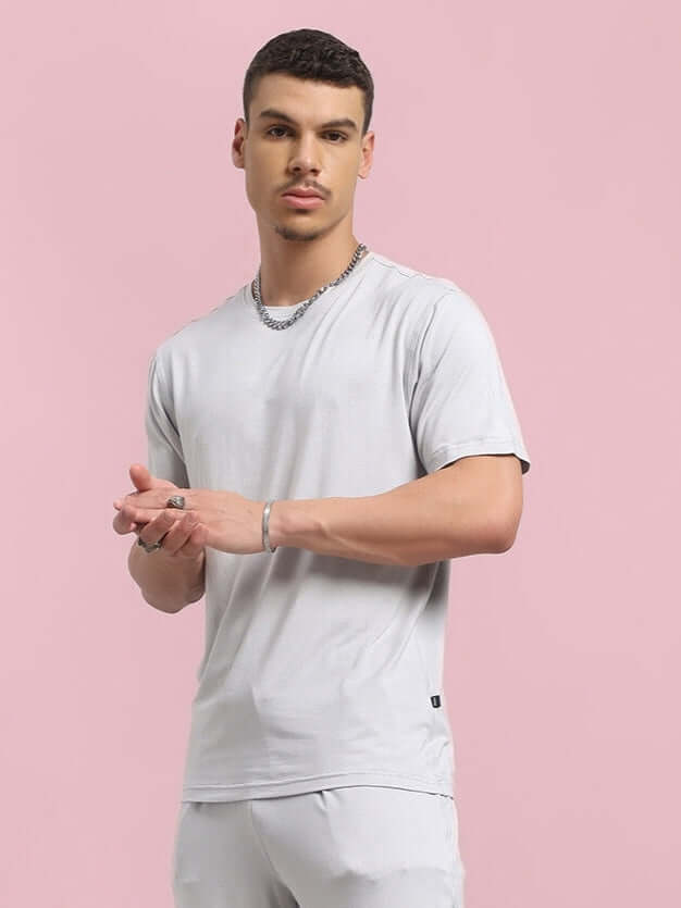 Model wearing AMBLE T-shirt in grey, made of premium heavy gauge modal fabric, available at Color By Colours, Noida, India.